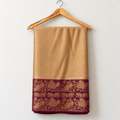 Brown & Gold Chettinad Silk Saree with Plum Peacock & Elephant Border — body and border on a wooden hanger