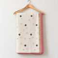 Ivory Jamdani Saree with Black Floral & Bird Pallu — body and border on a wooden hanger